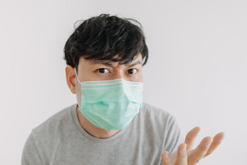 Close up of Happy Asian man wears mask isolated on white background.