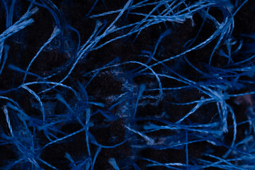 Close up of blue pile threads. Texture of yarn in macro.