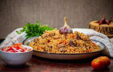 Delicious Fergana pilaf. Uzbek favorite dish on wooden background