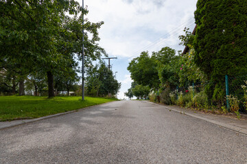 Village street between farm gardens and fruit tree meadows in the Swabian Jura