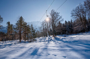 Winter Mountain landscape with ski lift in snowy forest recreation ski resort area in Bavaria,...