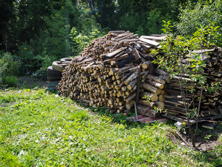 Fototapeta na wymiar Preparation of firewood for the winter. A pile of chopped firewood. Wooden background.
