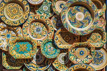 Erice, Sicily. Colorful hand-decorated ceramics. Traditional tourist suvenir. Street vendor with hand made crafts.Plates with ornamental decoration.Summer vacation in Italy,travel art scene