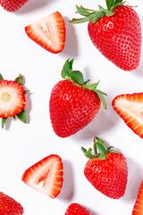 Whole and sliced strawberries on a white background