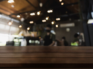 Obraz na płótnie Canvas Empty wooden table top with lights bokeh on blur restaurant background.