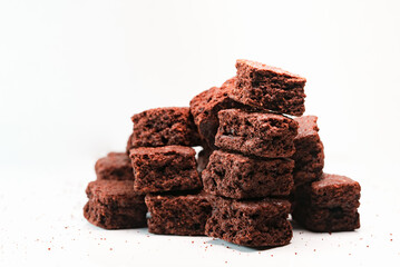 Extream close up shot of stack homemade chocolate brownies cracker, Pieces of fresh brownie on white background. Delicious chocolate pie.