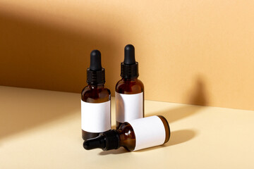 Serum and essential cosmetic oil bottle with dropper with shadows in the background. Cosmetic spa...