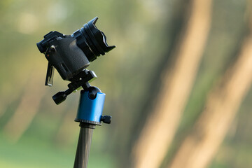 Photo camera on a tripod in the park
