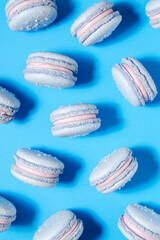 Fototapeta premium Blueberry french macaron cookies with blueberry buttercream filling on a bright blue background