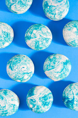 Blueberry swirl french macarons on a bright blue background