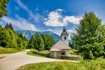 a chapel in slovenia in front of a mountain panorama