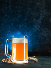 A mug of unfiltered wheat beer on a dark blue background