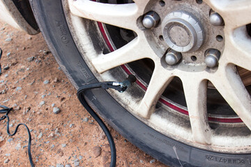 Inflating car tires with an air compressor. Wheel hub and air supply cable for tire inflation of...