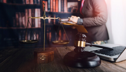 Business and lawyers discussing contract papers with brass scale on desk in office. Law, legal services, advice, justice and law concept picture with film grain effect
