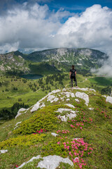 Fototapeta na wymiar hiking girl enjoying an epic view of Diemtigtal with Seebergsee in the Bernese Alps