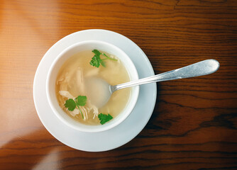 Turkish style delicious hot chicken soup in bowl on wooden table. 