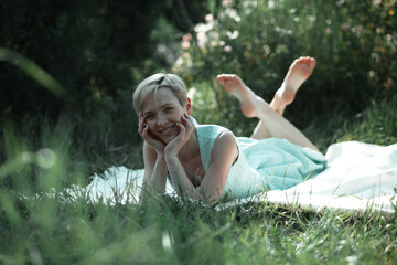 Naklejka na ściany i meble woman relaxing in the grass