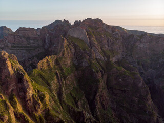 Aerial view of picturesque volcanic mountains at sunrise.