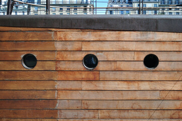 Three Portholes in Wooden Side of Canal Barge 