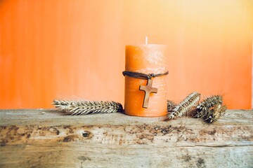 Candle with wooden cross and grain - greeting card and background for confirmation, communion,...