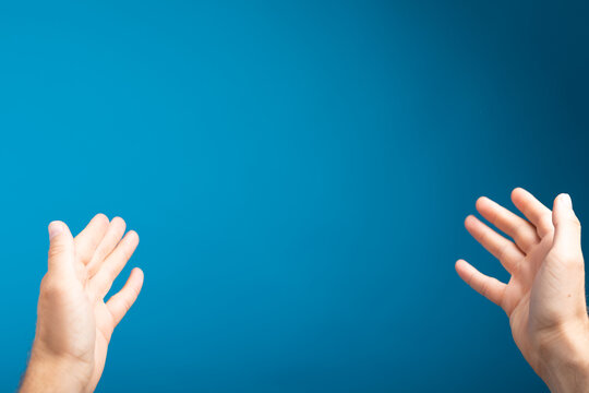 male  shows outstretched hand with open palm