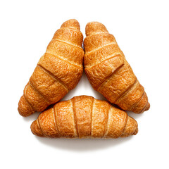 Three croissants are folded in the shape of a triangle, top view