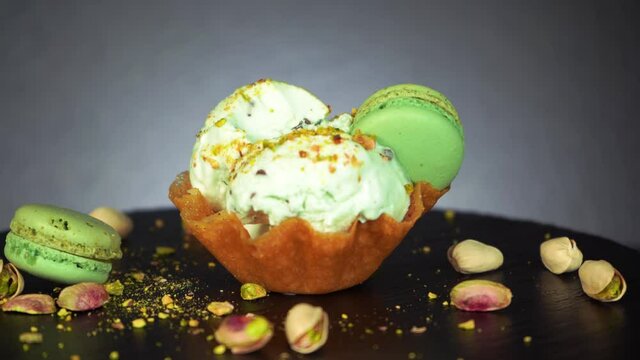 Spoon take a bite of green pistachio ice cream with macaroons, 4K nut crumbs