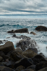 beach rocks seaside, atlantic ocean seascape, big stones, cloudy day moody ambience