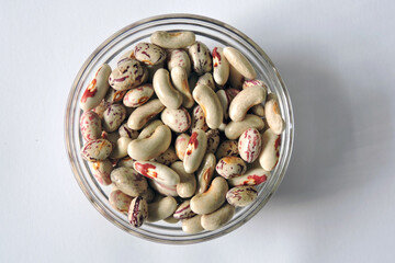 Colorful beans in a glass bowl,  white background