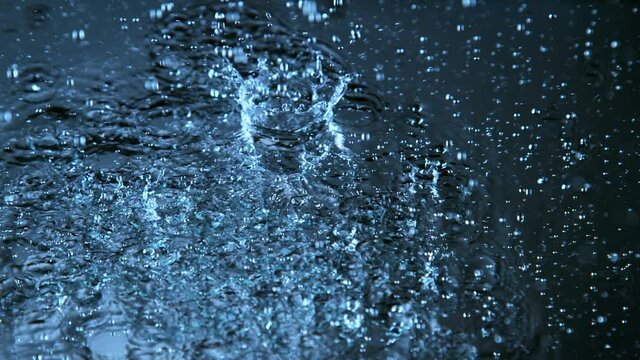 Super slow motion of raining water drops in detail. Filmed on high speed cinema camera, 1000fps.