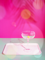 Romantic background with wine glass. Summer, holiday, relax composition with empty cocktail glass on a tray on a pink background with palm leaves shade. Holiday party concept