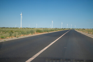 Wind farms on the road on a sunny day