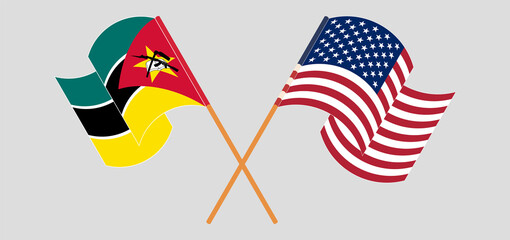 Crossed and waving flags of Mozambique and the USA