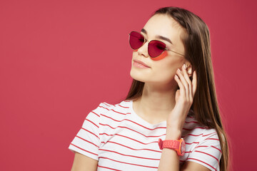 pretty woman wearing sunglasses hairstyle Glamor pink background