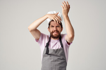 man in a chef's cap apron work as a cook restaurant kitchen