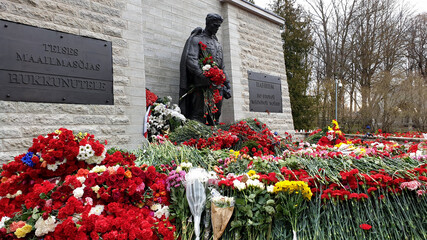 Bronze Soldier monument in Tallinn. Red Army veterans celebrate Victory Day on May 9th by bringing...