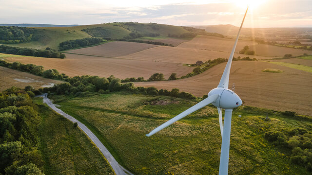 Lonely wind turbine in farm fields, East Sussex, UK.