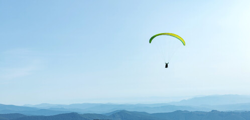 Paragliding in mountains Extreme sport with parachute. Paragliding People fly using Parachute. Long Web banner