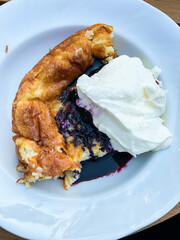 Oven baked pancake with cream and jam.