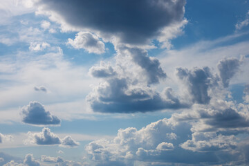 White clouds on blue sky background. Bright view of natural scene at sunny day.