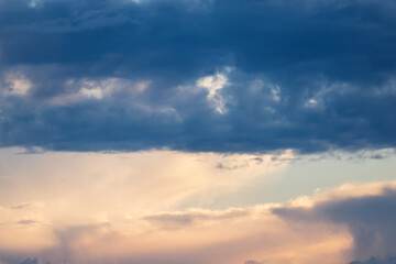 Colourful sunset skyline with light and dark clouds. Beautiful natural view of free space. Lovely sundown background.