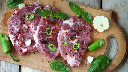Fresh raw meat steaks on a wooden board. Grilling meat.