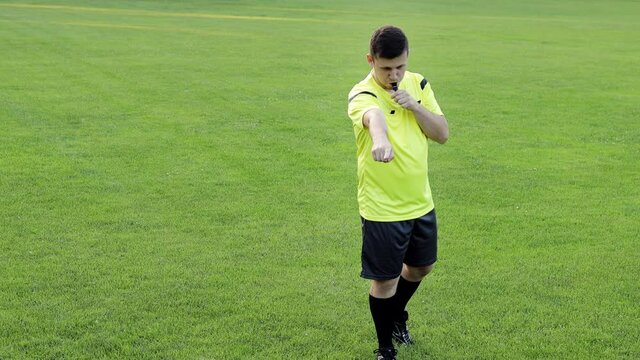 Referee goes watching VAR or violation of the rules and shows a penalty, yellow or red card . Concept of sport, rules violation, offside.