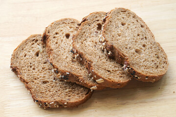 whole wheat breads sliced on wooden background