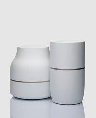 White plastic ashtrays on white background