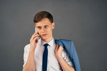 manager with a jacket on his shoulder talking on the phone professional work