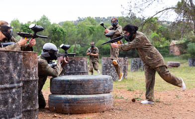 Fototapeta premium Two opposing teams facing on battlefield in outdoor paintball arena