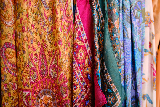 Colorful traditional middle eastern shawls hanging at bazaar. Multi-colored headscarfs