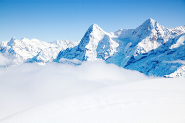 Fototapeta na wymiar white winter background with snowy peaks in the Swiss Alps