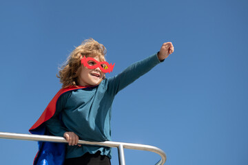 Super hero child in a red superhero coat. Super hero concept.